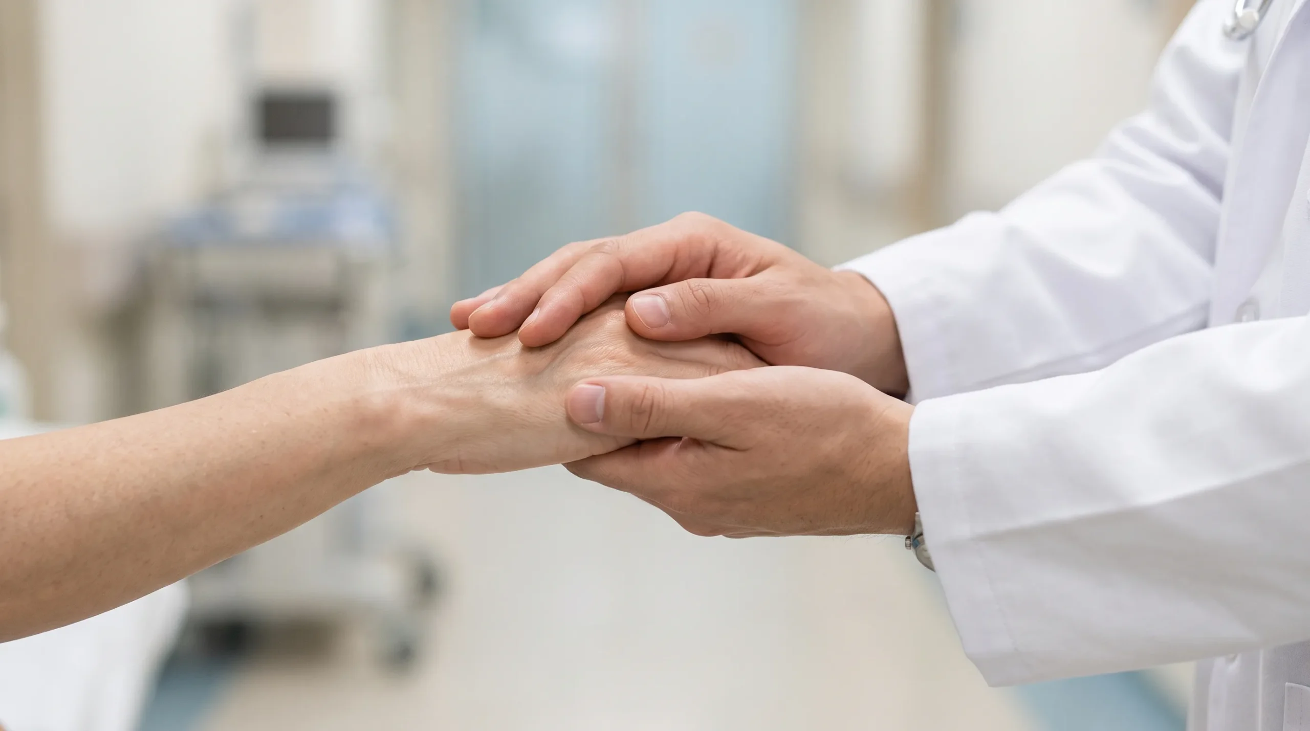 A doctor holding a patient hand at City Clinic Wah